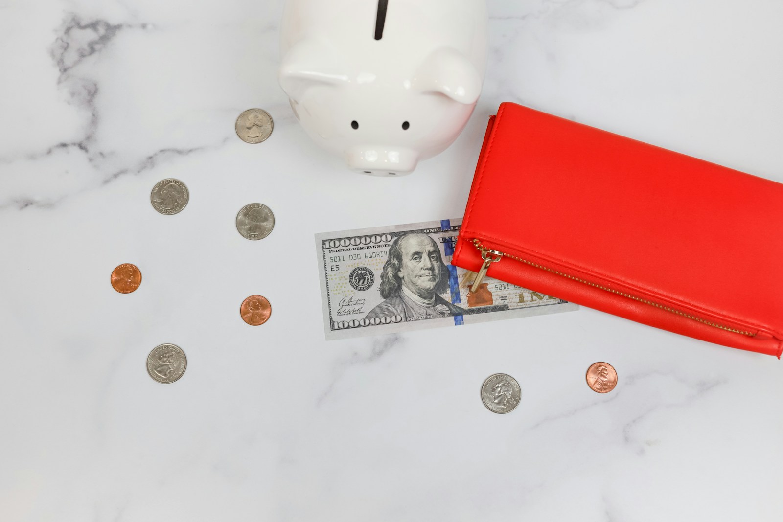 a piggy bank and coins in the snow